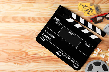 Flat lay composition with clapperboard and 3D glasses on wooden table, space for text