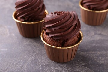 Delicious chocolate cupcakes on grey table, closeup
