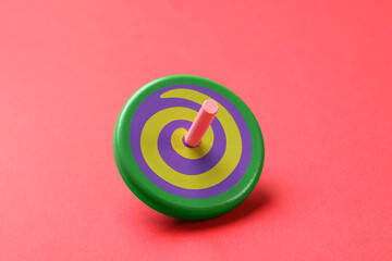 One colorful spinning top on red background
