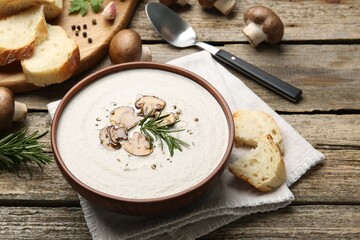 Fresh homemade mushroom soup served on wooden table