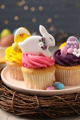Tasty decorated Easter cupcakes on wooden table
