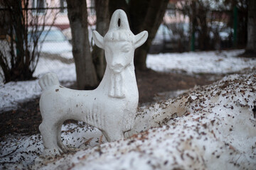 Goat statue. Figure of a goat in the park. Plaster sculpture.