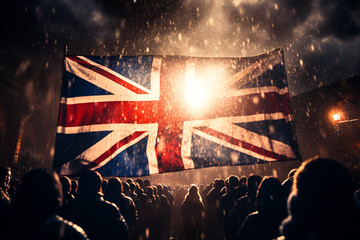 Crowd of people with flags of Great Britain and United Kingdom at night