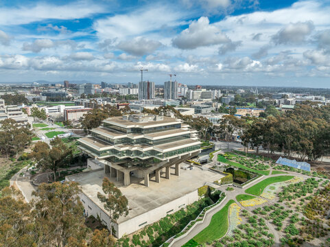 Aerial view of Geysel library at the University of California San Diego, futuristic building, columns holding up upper floor like books, next to the snake path
