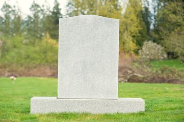A blank tombstone in a cemetery.