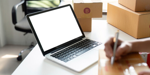Mockup of white empty display laptop with box. Concept of online business