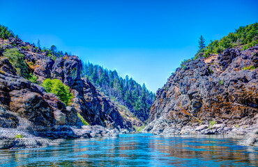 defocused Water level view of Hellgate Canyon on the wild and scenic Rogue River  - obrazy, fototapety, plakaty