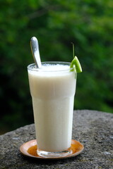 Jus Sirsak, soursop juice in a clear glass. Soursop is a flowering plant that comes from the Caribbean, Central America and South America. Annona muricata. 