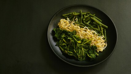 Urap, Indonesia traditional food served on plate. Salad dish consist of steamed vegetables such as...