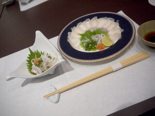 Plate of fugusashi or Japanese fugu blowfish sashimi thin transparent slices