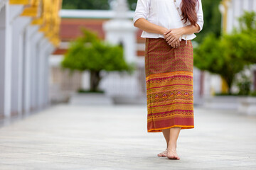 Buddhist asian woman is doing walking meditation around temple for peace and tranquil religion...