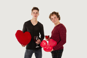 Gay couple. Two young attractive guys are drinking red wine.