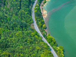 Aerial photography of the winding mountain road by the river