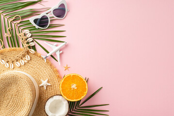 Flat lay of summer beach essentials with sunglasses, a straw hat, tropical palm leaves, orange...