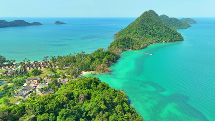 The drone's eye captures the mesmerizing beauty of a tropical sea, where crystal-clear waters kiss sandy beaches. Nature's masterpiece unfolds. Ko Chang island, Thailand. 
