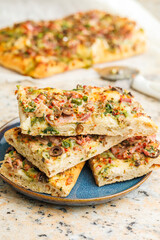Tasty italian square pizza on kitchen table.