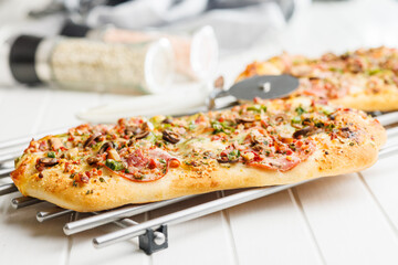 Tasty italian square pizza on kitchen table. - 794763328