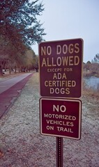 Warning signs at the start of a park walking trail
