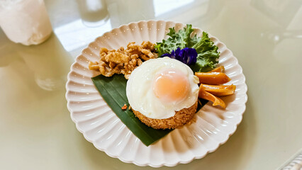 American fried rice is a Thai fried rice dish with American side ingredients like fried chicken, ham, sausages, raisins, and ketchup