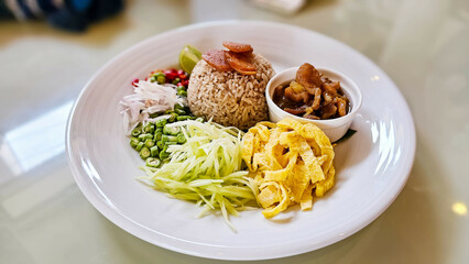 Thai Food Khao Kluk Kapi. Shrimp Paste Fried Rice served with various sides or toppings, Sliced omelette, Sweet pork, Green mangoes And vegetables. Thai restaurant. Thai Cuisine.