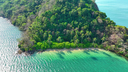 Experience tropical bliss from a bird's-eye view. Crystal-clear sea, sandy shore, and lush coconut...