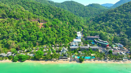 Aerial view of a tropical paradise, Crystal-clear waters meet golden shores, lined with luxury...