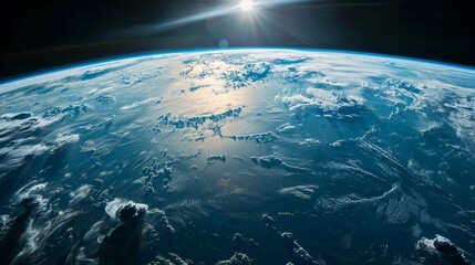 The sun casts its light on Earth from the vastness of space, with the curvature of our planet...