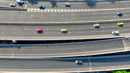 Aerial view, Swiftly soaring above the bustling expressway, the drone captures the dynamic flow of...