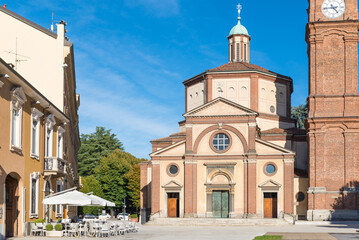 Square with church, bell tower and bar. Historic center of Legnano city, piazza San Magno (square Saint Magno) with the Basilica of San Magno (XVI century), Lombardy region, Italy - obrazy, fototapety, plakaty