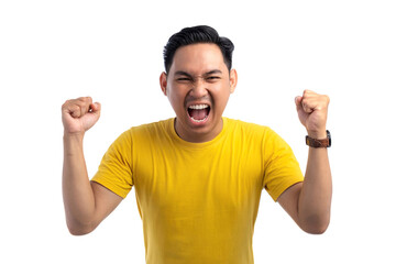 Excited handsome Asian man doing winner gesture with arms raised, shouting, celebrating success isolated on white background