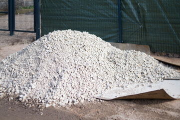 A pile of construction material at the building. White gravel for construction  works