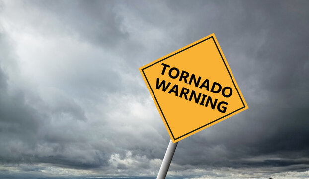 Hurricane Idalia warning sign against a powerful stormy background with copy space. Dirty and angled sign with cyclonic winds add to the drama.hurricane season sign on cloudy background