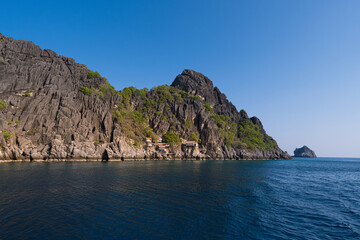 Scenic view of a hidden village by the sea, surrounded by towering rock formations at Chumporn sea, Thailand
