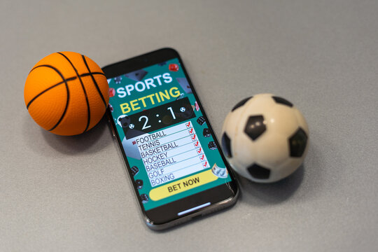 smartphone with application for sport bets and a basketball ball, concept of online bets 