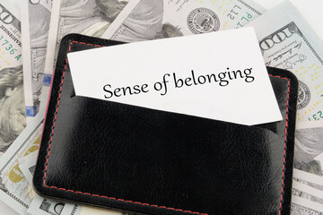 Business, sense of belonging concept. Text Sense of belonging on a business card in a leather...