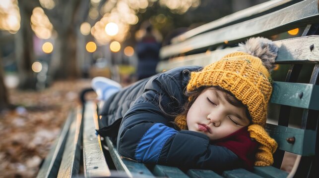A young child curled up in a ball on a park bench, visibly upset and alone