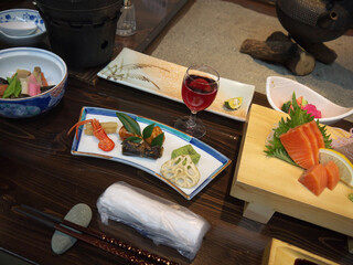 Traditional japanese fancy ryokan dinner with kaiseki appetizers and shot glass of liquor served...