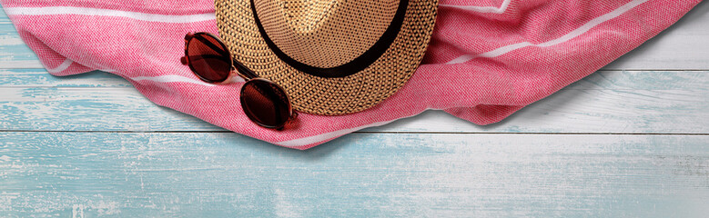 Summer Straw Hat, Towel and Sunglasses on Wooden Surface. File with Clipping Path.