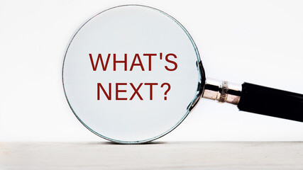 Business concept. What is next text appeared through a magnifying glass on a white background