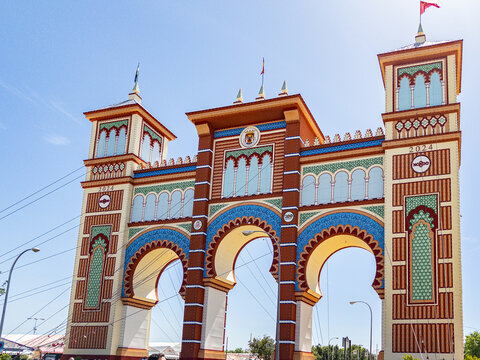 Entrance known as the Portada to the Seville Fair known as Fiera de Abril is held in Seville, Andalusia for a week. Women dress in Flamenco dresses and men in smart suits.