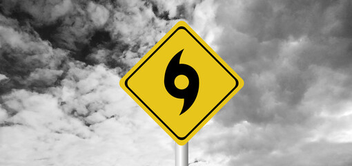 Hurricane Idalia warning sign against a powerful stormy background with copy space. Dirty and angled sign with cyclonic winds add to the drama.hurricane season sign on cloudy background