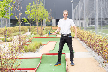 player looks at his hit on a mini golf course