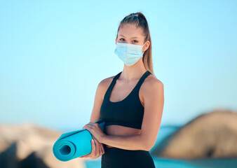 Face mask, yoga mat or girl at beach for wellness, meditation and morning practice for zen in nature. Balance, spirituality or woman at sea for holistic exercise with mouth cover for Spain compliance