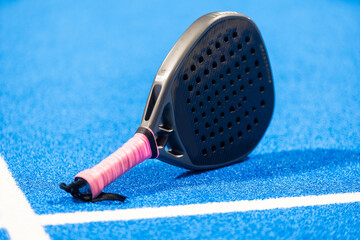 Paddle racket, next to the ball and on a carpet of the play area - 794868926
