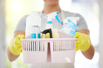 Person, hands and basket with cleaning supplies for disinfection, housekeeping or domestic...