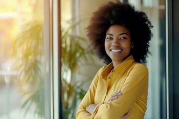 Confident afro professional crossed arms in a modern office