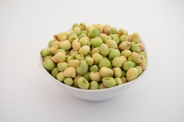 Fresh Green black eyed peas beans lili chori in a white bowl on white background