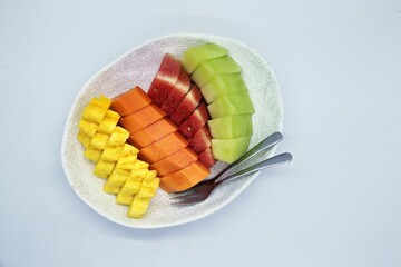 Fresh cut fruits on big bowl. Watermelon, muskmelon and papaya cuts. For buffet menu. on plate with...