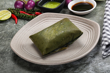 Asian cuisine - rice with filling in banana leaf