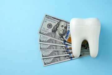 Dollar money bills and tooth model on a bluebackgound with copy space - 794896955